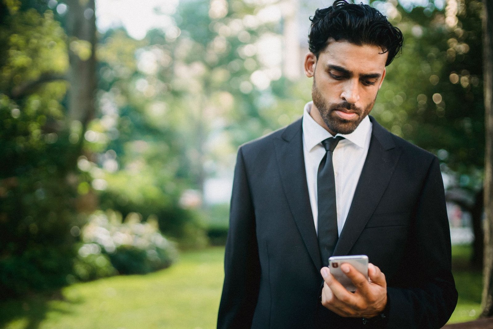 A person looking down at a phone with the head held in sustained forward flexion