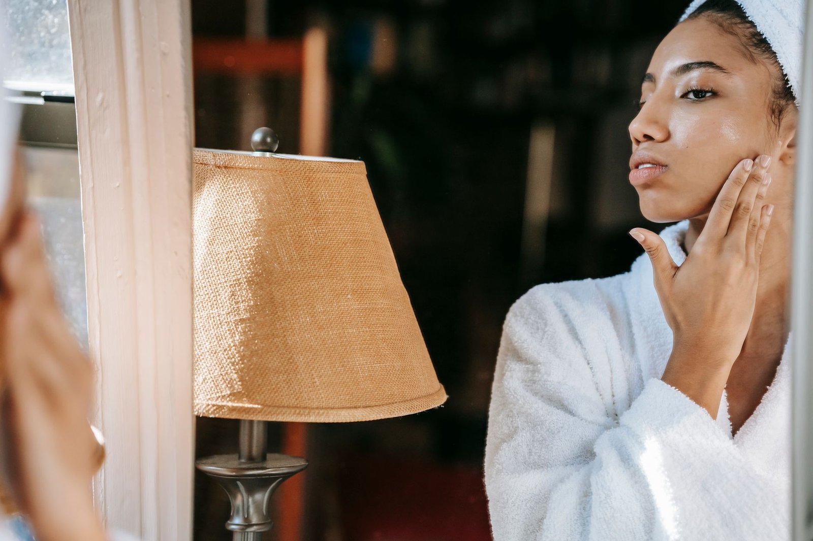 A person with a hand held to one cheek, the light-touch trigger zone of trigeminal neuralgia