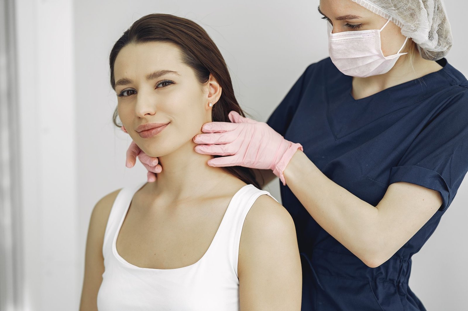 A clinician examining a patient neck and shoulder during an assessment