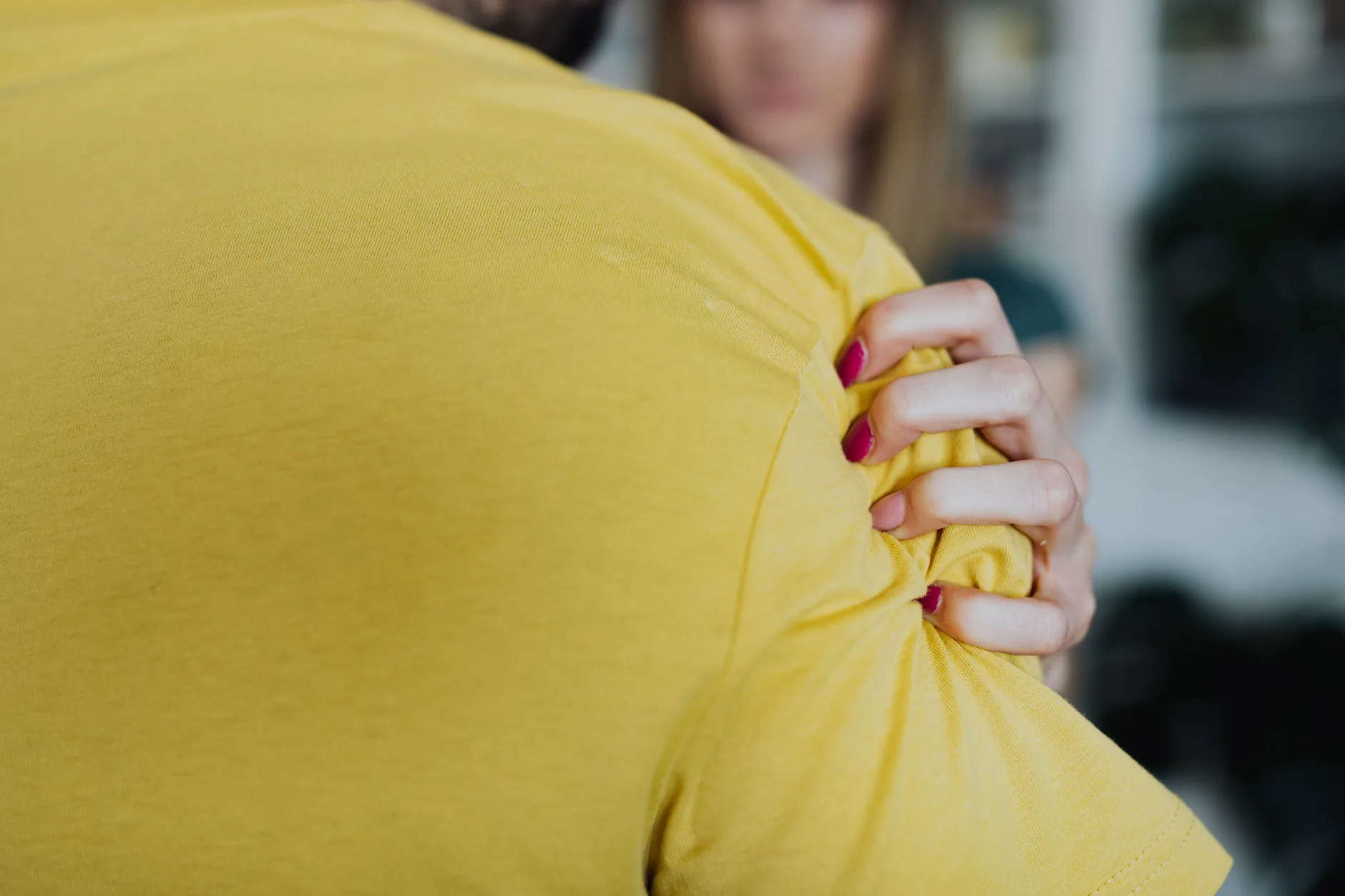 A hand grips the outer shoulder, pain that can come from the neck rather than the shoulder joint